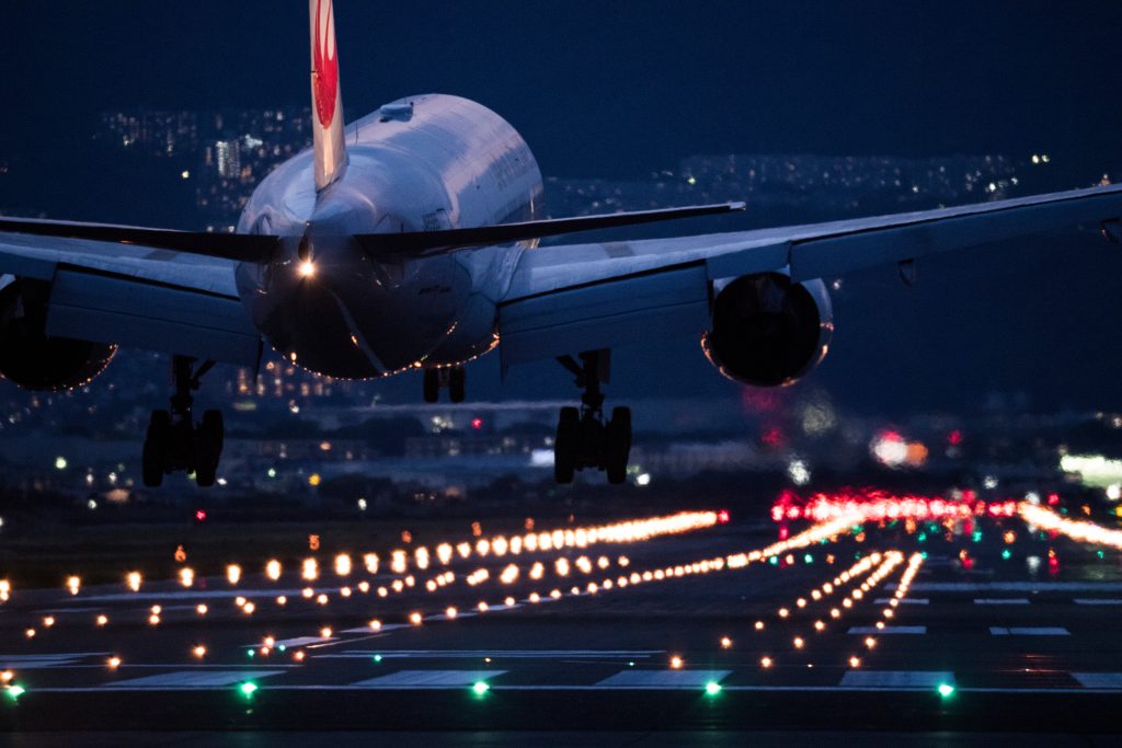 An airplane trying to land at the airport at night